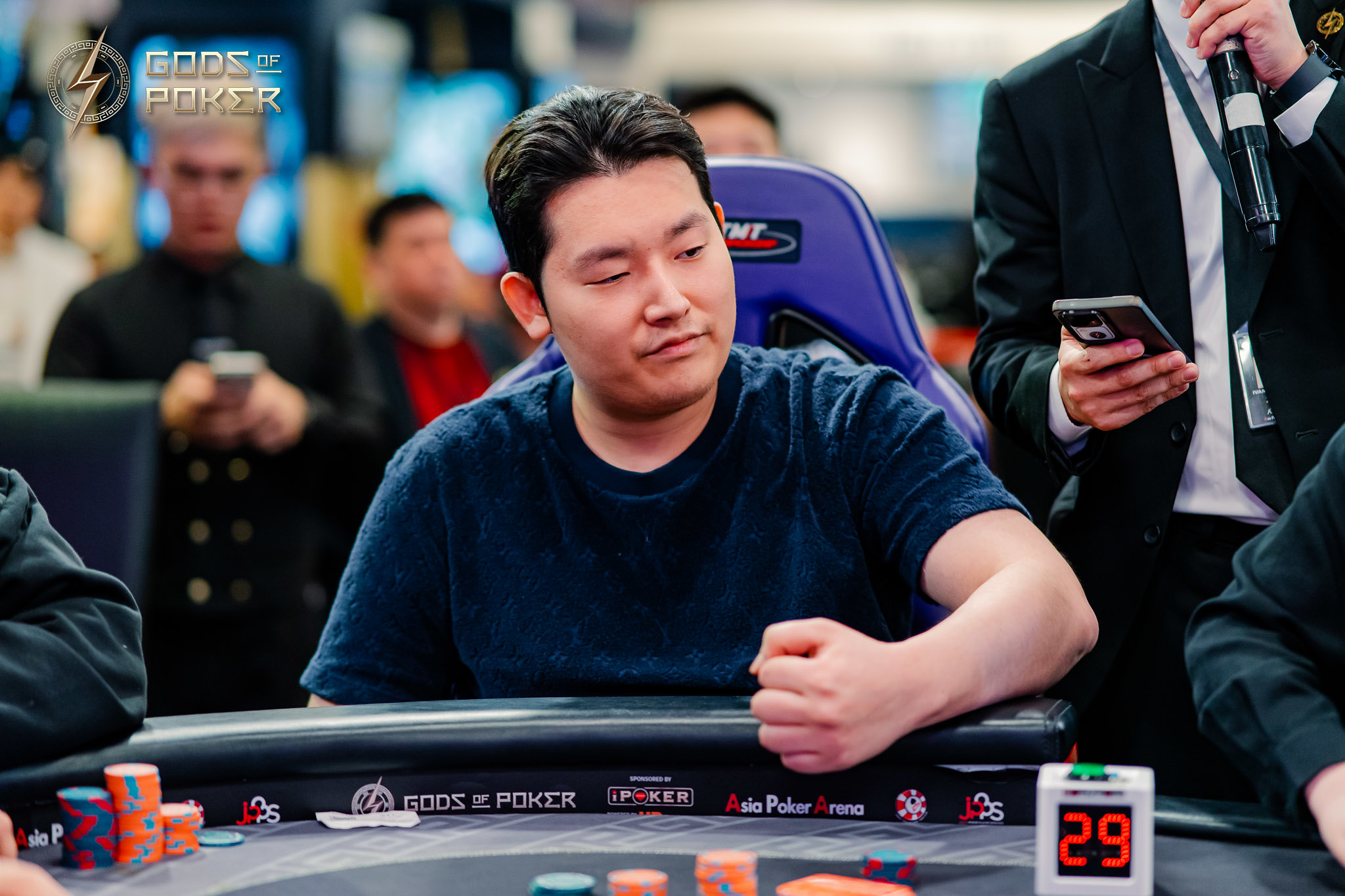 A focused man at a poker table with chips, contemplating his next move.