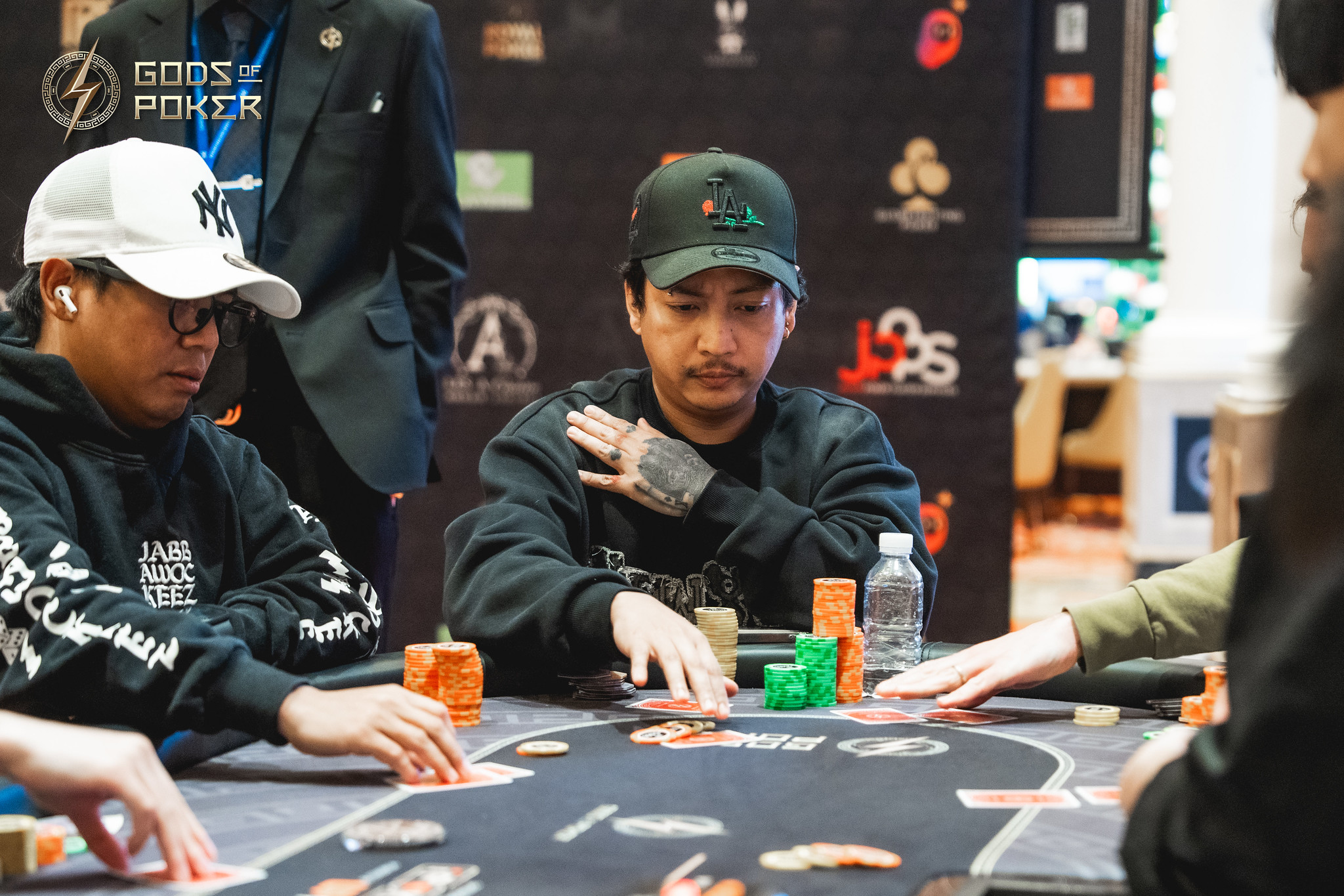 Two men intensely focused on their cards during a high-stakes poker game.