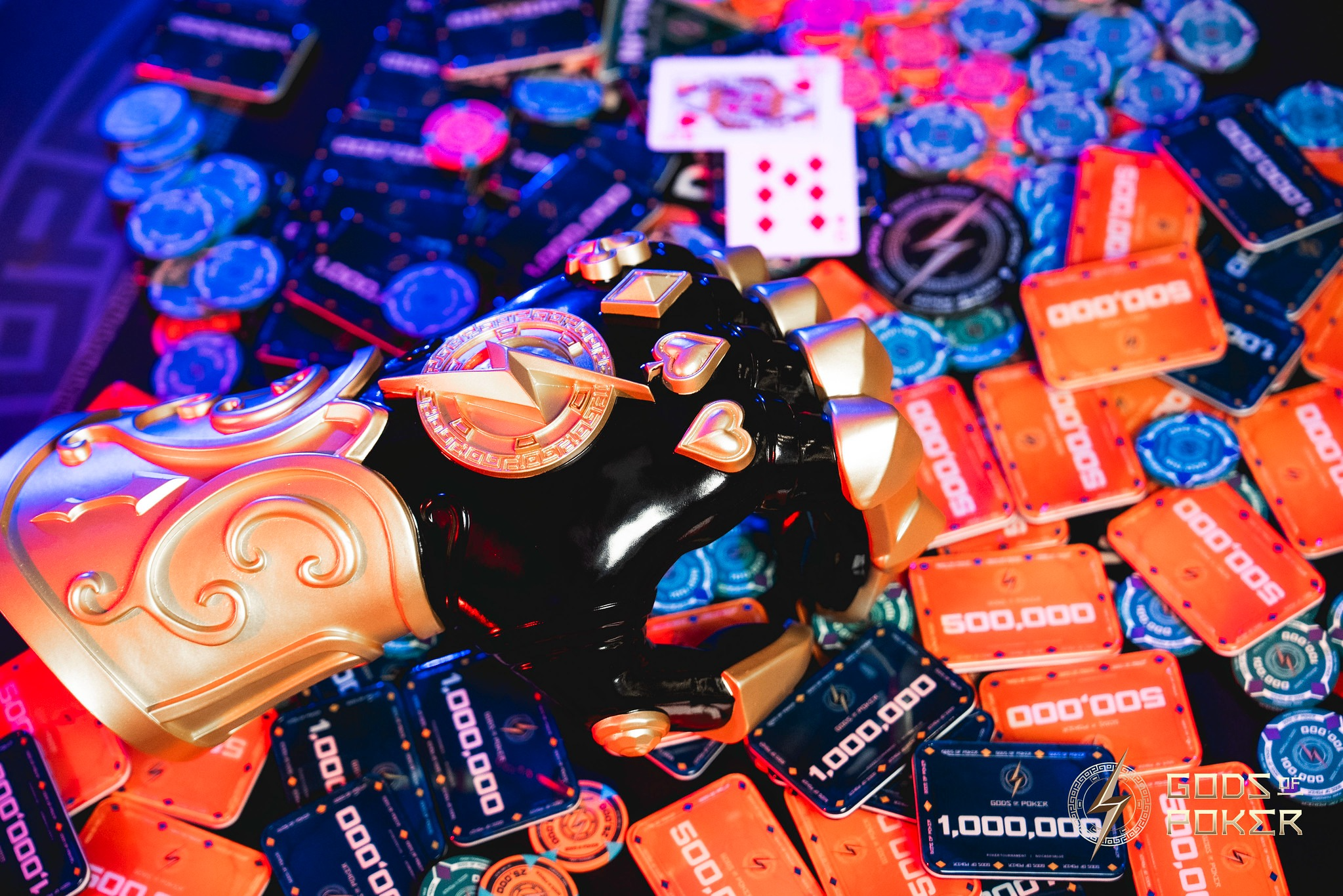 A golden poker trophy, surrounded by high-value casino chips and playing cards.
